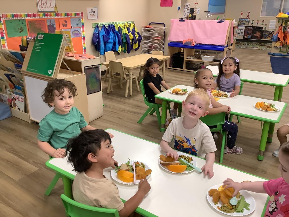 Preschoolers showing their summer sun paper-plate art