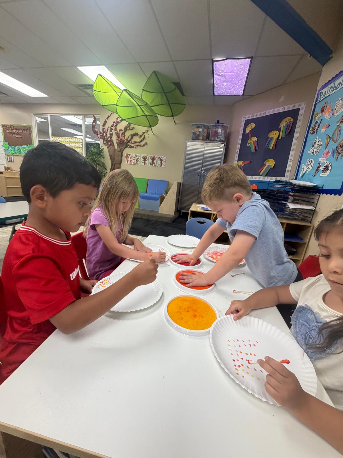 Children working on a paper-plate painting craft
